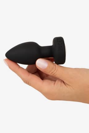 Analplugs Anos - RC Flashing Butt Plug with Vibration - Kompakter Silikon-Buttplug: wasserdicht, USB-ladbar, 7 Modi – Du bestimmst per Fernbedienung. Bunt blinkende LED und sicherer Fuß bringen extra Spielspaß, ganz ohne Stress.